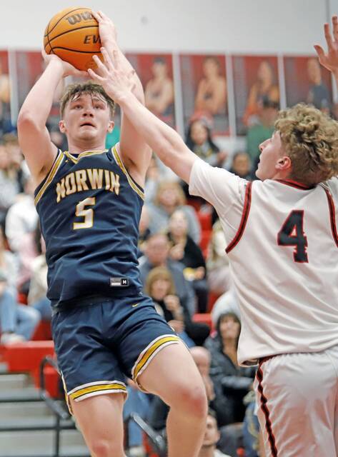 Norwins Alex Graney attempts a jumper over the defense of Fox Chapels Jackson Helgert on Monday. (Josh Rizzo | For TribLive)