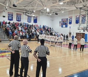 Spectators, officials and teams stand for the national anthem Monday night at Jeannette. (Bill Beckner Jr. | TribLive)