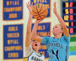 Burrells Chase Coury (front) finds room to attempt a shot over Hamptons Brynn Rodgers on Monday at Hampton High School in the WPIAL Class 4A first-round playoffs. (Andrew Palla | For TribLive)