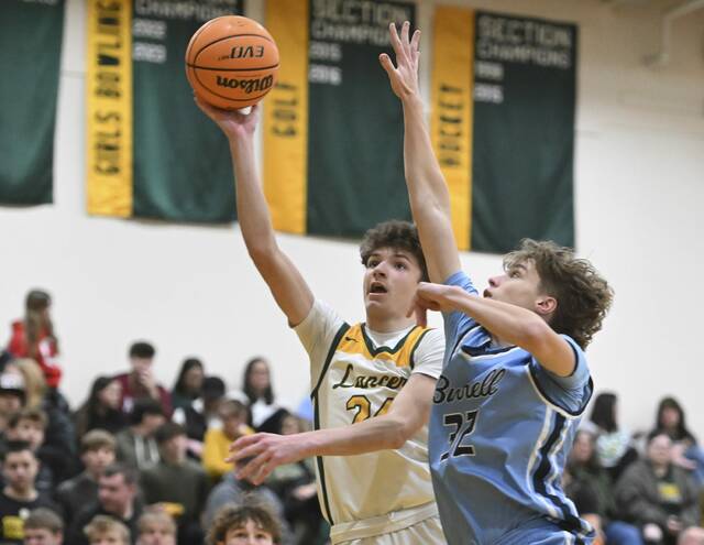 Deer Lakes Evan Moore scores past Burrells Gavyn Orr on Jan. 20. (Chaz Palla | TribLive)