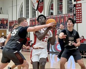 Sewickley Academy's Mamadou Kane drives on Greensburg Central Catholic's JT Botti in the Class 2A first round Monday, Feb. 16, 2026. (Antonio Rossetti | For TribLive)
