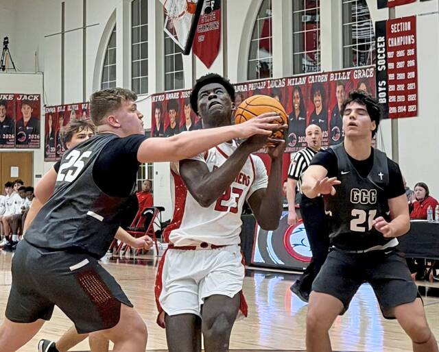 Sewickley Academy's Mamadou Kane drives on Greensburg Central Catholic's JT Botti in the Class 2A first round Monday, Feb. 16, 2026. (Antonio Rossetti | For TribLive)