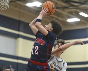 Shalers Jordan Epps scores over Franklin Regionals Colin Holt during their WPIAL Class 5A first-round game Tuesday at Franklin Regional High School. (Chaz Palla | TribLive)