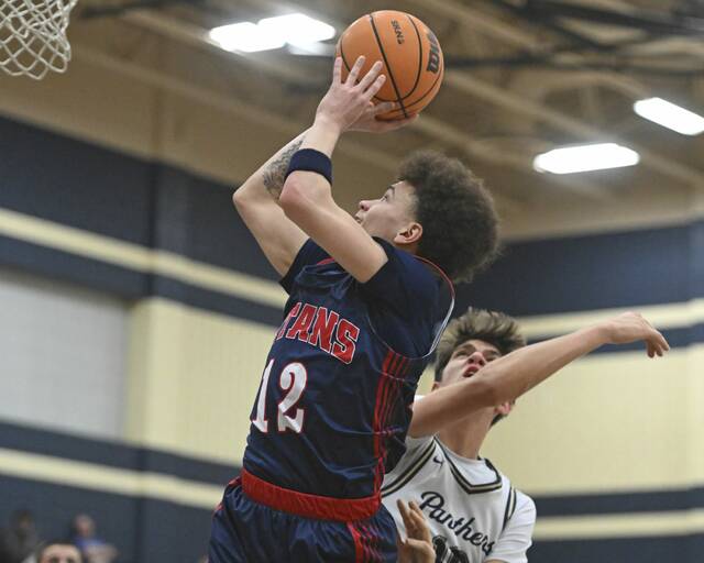 Shalers Jordan Epps scores over Franklin Regionals Colin Holt during their WPIAL Class 5A first-round game Tuesday at Franklin Regional High School. (Chaz Palla | TribLive)