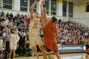Thomas Jefferson’s Justin Fry (left) drives for a layup against Latrobe’s Ian DeCerb during Tuesday's WPIAL Class 5A first-round playoff game. (Brennan Valladares | For TribLive)