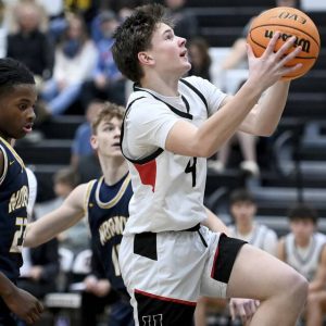 Upper St. Clairs Andrew Gaither scores past Norwins Chris McKnight on Dec. 9, 2025. (Christopher Horner | TribLive)
