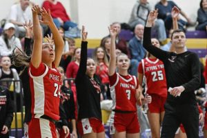 Peters Townships Taylor McCullough (24) drills a 3-pointer in front of the Indians bench against Plum in the WPIAL Class 5A first round Friday, Feb. 13, 2026, at Plum. (Andrew Palla | For TribLive)