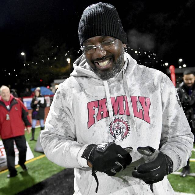 Aliquippa coach Mike Warfield smiles after getting soaked by the water cooler late in the PIAA Class 4A championship game against Dallas on Dec. 7, 2023. (Christopher Horner | TribLive)