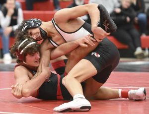 Peters Townships Dane McMillon wrestles Fox Chapels Andrew Kratsa at 145 pounds Dec. 3. (Chaz Palla | TribLive)