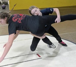 Gateway junior Savannah Boden works to take down sister Sierra, a freshman, during a practice in Feburary in the wrestling room at Gateway’s Furrie Sports Complex. Six Gators wrestlers will compete at the WPIAL girls championships Feb. 20, 2026, at Mt. Lebanon High School. (Michael Love | TribLive)