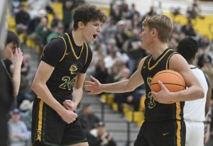 Deer Lakes Collin Rodgers celebrates with Evan Moore after scoring an and-one against Hopewell during the WPIAL Class 4A quarterfinals Wednesday, Feb. 17, 2026 at North Allegheny High School. (Chaz Palla | TribLive)