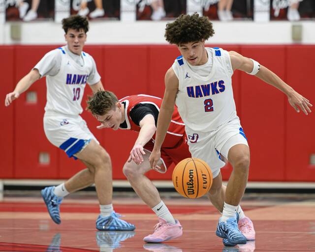 Jeannette's Jayce Powell (front) pokes the ball away from Eden Christian Academy's Michael Sample (center) on Thursday, Feb. 19, 2026, at Fox Chapel. (Andrew Palla | For TribLive)