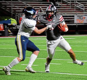 Southmorelands Jackson Mickens (11) tries to fend off a tackle by Hopewells Nick Thomas during a WPIAL Class 3A first-round game Oct. 31, 2025, at Southmorelands Russ Grimm Field. (Jason Black | Daily Courier)
