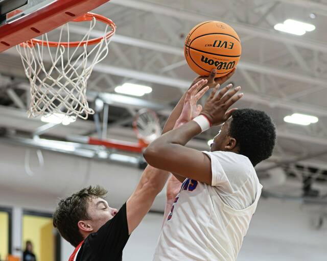 Jeannette's Marcus McGowan (right) attempts a pull-up jumper against Eden Christian Academy on Thursday, Feb. 19, 2026, at Fox Chapel. (Andrew Palla | For TribLive)