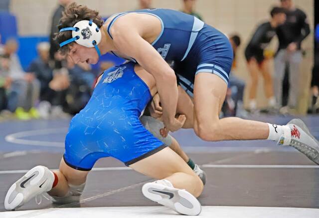 Burrell's Julian Bertucci stuffs a takedown attempt by Beaver County Christian's Cole Stroupe during the Round of 16 at the WPIAL Class 2A individual wrestling championships Friday at Chartiers Valley High School. (Josh Rizzo | For TribLive)