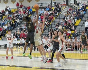 Gateways Nehemiah Nichols goes to the basket as Moons Jackson Bauman defends in the WPIAL Class 5A quarterfinals Friday. (James Dotson | For TribLive)