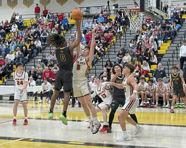 Gateways Nehemiah Nichols goes to the basket as Moons Jackson Bauman defends in the WPIAL Class 5A quarterfinals Friday. (James Dotson | For TribLive)