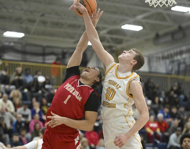 Thomas Jeffersons Justin Fry blocks the shot of Penn Hills Calix Clark during the WPIAL Class 5A quarterfinals Friday at Norwin. (Chaz Palla | TribLive)