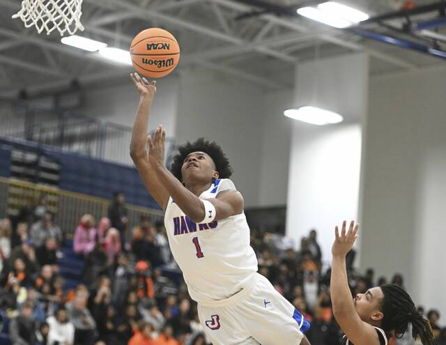Jeanettes Kymone Brown drives past Clairtons Donte Wright during the WPIAL Class 2A semifinals Monday at Norwin. (Chaz Palla | TribLive)