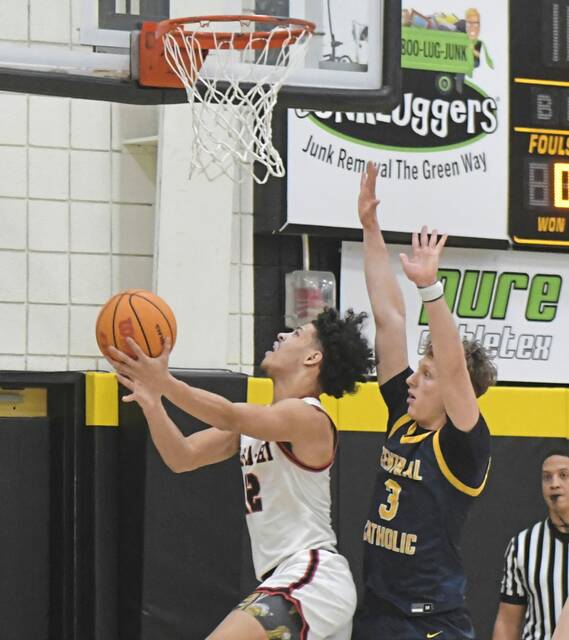 New Castle sophomore Kai Cox hits a layup against Central Catholics Enzo Khalil (3) during a WPIAL Class 6A semifinal Monday. (Paul Schofield | TribLive)