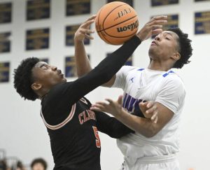 Jeanettes Noah Sunder fights for a rebound with Clairtons Brandon Murphy during the WPIAL Class 2A semifinals Monday at Norwin. (Chaz Palla | TribLive)