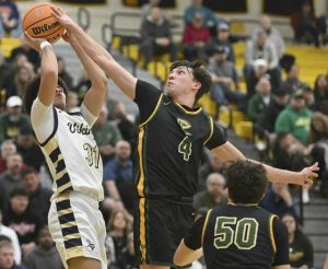 Deer Lakes Luca Mangieri blocks the shot of Hopewells Justin Shegog during the WPIAL Class 4A quarterfinals Feb. 17, 2026 at North Allegheny High School. (Chaz Palla | TribLive)
