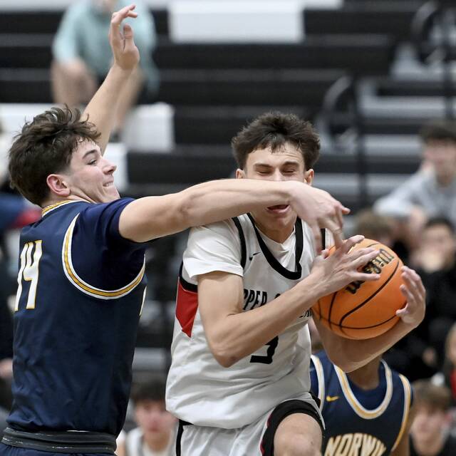 Upper St. Clairs Jake Foster drives to the basket against Norwins Josh Lenart on Dec. 9, 2025. (Christopher Horner | TribLive)