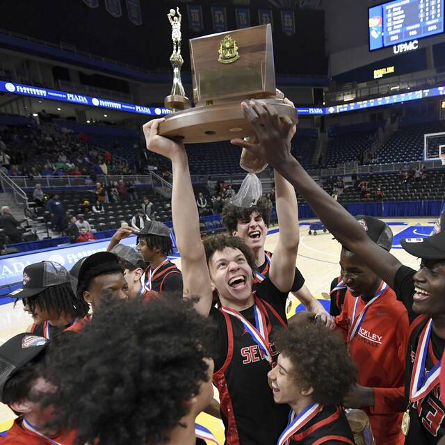 The Sewickley Academy boys basketball team celebrates with the WPIAL championship trophy after defeating Jeannette in the Class 2A final on Friday, Feb. 27, 2026, at Petersen Events Center. (Christopher Horner | TribLive)