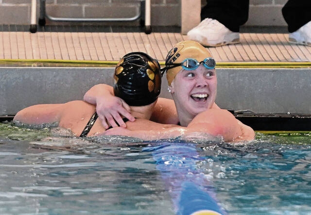 Kiski Areas Leah Kunkle hugs North Alleghenys Tori Tieppo after beating her in the girls 100 breaststroke during the WPIAL Class 3A swimming championships Friday at Pitts Trees Pool. (Chaz Palla | TribLive)