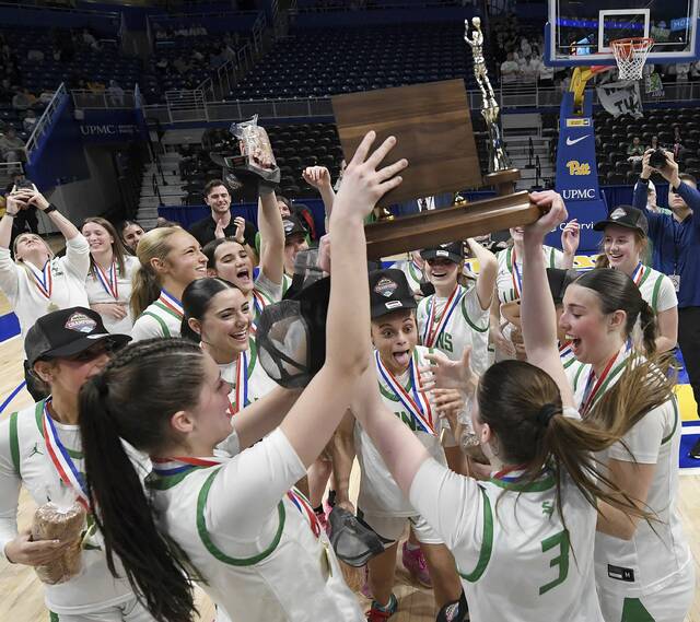 The South Fayette girls basketball team celebrates with the WPIAL championship trophy after defeating Thomas Jefferson in the Class 5A final on Friday, Feb. 27, 2026, at Petersen Events Center. (Christopher Horner | TribLive)