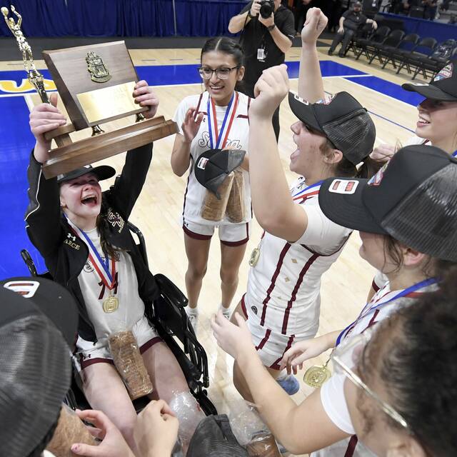 Serra Catholics Lexi Pearce hoists the WPIAL championship trophy with his teammates after defeating Geibel Catholic in the Class A final on Friday, Feb. 27, 2026, at Petersen Events Center. (Christopher Horner | TribLive)