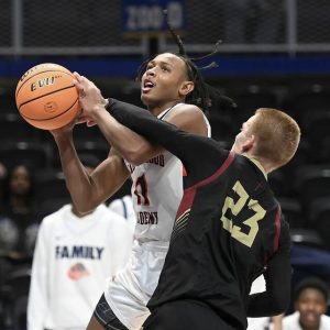 The Neighborhood Academys Kedron Gilmore drives to the basket against Serra Catholics Tyler Sapida during the WPIAL Class A championship game Thursday at Petersen Events Center. (Christopher Horner | TribLive)