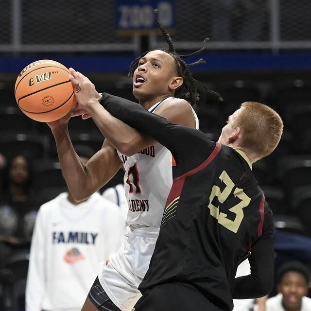The Neighborhood Academys Kedron Gilmore drives to the basket against Serra Catholics Tyler Sapida during the WPIAL Class A championship game Thursday at Petersen Events Center. (Christopher Horner | TribLive)