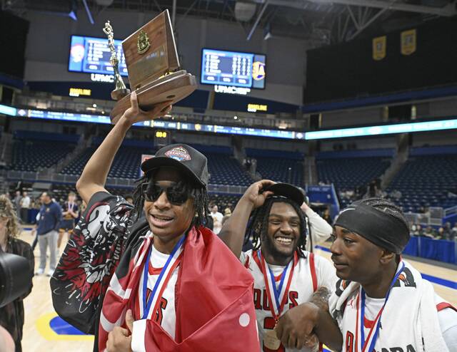Aliquippas Qalil Goode celebrates with the trophy after beating South Allegheny during the WPIAL Class 2A boys basketball championships Saturday, Feb. 28, 2026 at Petersen Events Center. (Chaz Palla | TribLive)