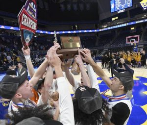 The Chartiers Valley boys basketball team celebrates with the WPIAL championship trophy after defeating Thomas Jefferson in the Class 5A final on Saturday, Feb. 28, 2026, at Petersen Events Center. (Christopher Horner | TribLive)