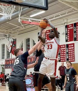 Sewickley Academy's Adam Ikamba shoots over Greensburg Central Catholic's JT Botti in the Class 2A first round Monday, Feb. 16, 2026. (Antonio Rossetti | For TribLive)
