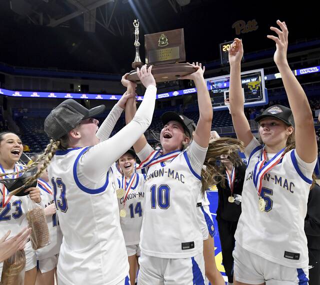 The Canon-McMillan basketball team celebrates with the WPIAL championship trophy after defeating Norwin in the Class 6A final on Saturday, Feb. 28, 2026, at Petersen Events Center. (Christopher Horner | TribLive)