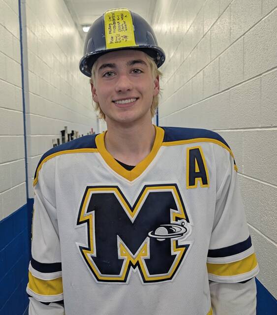 Mars Grant Weaver wears the player of the game hard hat after scoring a hat trick against Plum in the PIHL Class A playoffs Monday. (Michael Love | For TribLive)