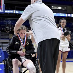 Serra Catholics Lexi Pearce receives her gold medal from coach Mike Voit after defeating Geibel Catholic in the WPIAL Class A championship game Friday at Petersen Events Center. (Christopher Horner | TribLive)