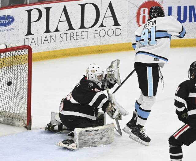Seneca Valleys Owen Martin watches John Sroka IIIs shot as it beats Upper St. Clairs Owen Laurent during the 2025 PIHL Class 3A semifinals. (Chaz Palla | TribLive)