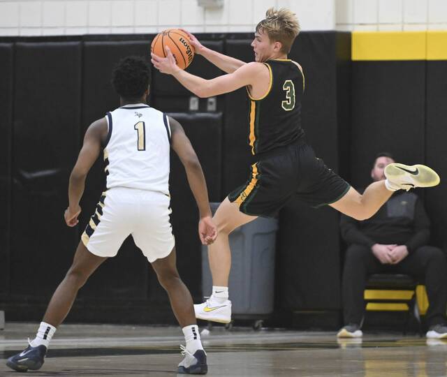 Deer Lakes Collin Rodgers steals a pass intended for Hopewells Tre Cameron during a WPIAL Class 4A quarterfinal Feb. 17 at North Allegheny. (Chaz Palla | TribLive)