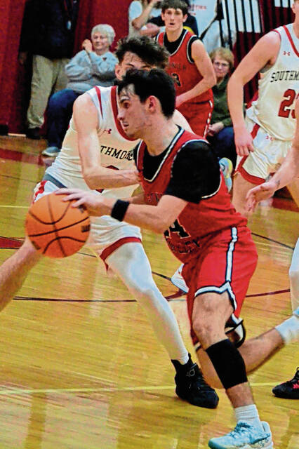 Ligonier Valleys Noah Knupp dribbles around Southmorelands Brady Sherbondyin the WPIAL Class 3A seventh-place game Feb. 25. (Paul S. Brittain | Daily Courier)