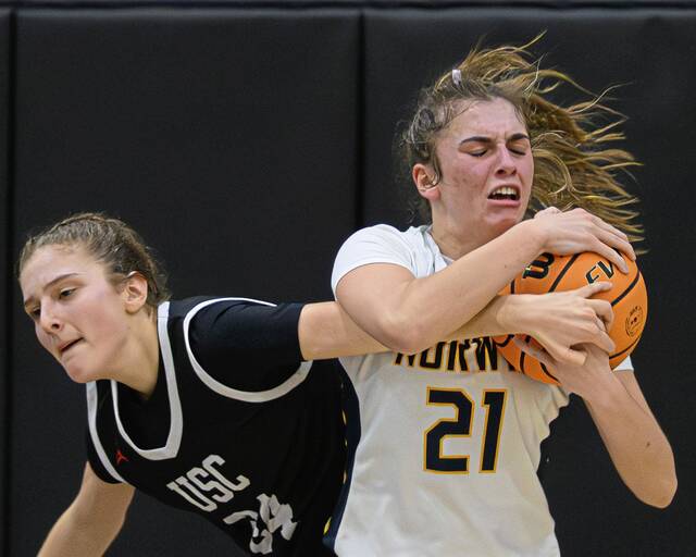 Norwins Elizabeth Yarosik (right) muscles a rebound away from Upper St. Clairs Claire Birmingham on Feb. 24 at Keystone Oaks. (Andrew Palla | For TribLive)