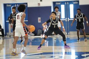 Monessens Tayvin Craggette defends on Neighborhood Academys Kedron Gilmore in the WPIAL Class A semifinals. (Jeff Helsel | Mon Valley Independent)