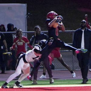 Penn Hills Carter Bonner catches a touchdown pass over Alquippas Larry Moon on Sept. 20, 2024, at Penn Hills High School. (Christopher Horner | TribLive)