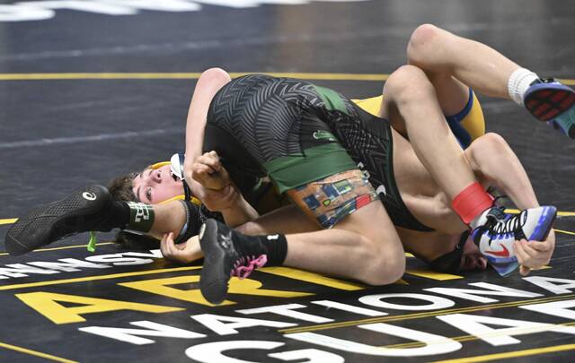 Derrys Patrick Bulger beats Trinitys Camron Smith at 114 pounds during a first-round match at the PIAA Class 2A wrestling championships Thursday at Hersheys Giant Center. (Chaz Palla | TribLive)