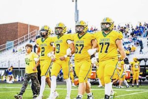 Marco Mangieri, at left, with brothers Luca and Dante Mangieri and fellow captains Joey Ashi and Shaun Bier, take the field for the coin toss before Deer Lakes game with Derry on Sept. 5, 2025, at Lancers Stadium. (Submitted | Erica Mangieri)
