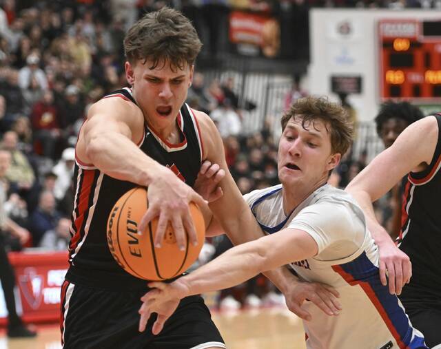 Moons Braeden Stuart fights for a loose ball with Chartiers Valleys Danny Slizik during the WPIAL Class 5A semifinals Feb. 24 at Peters Township. (Chaz Palla | TribLive)