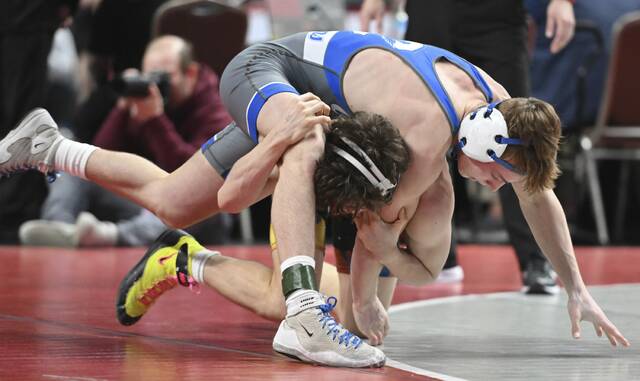 Connellsvilles Tommy Gretz beats DuBois Mateo Gallegos during a PIAA Class 3A 121-pound semifinal Friday at Giant Center. (Chaz Palla | TribLive)