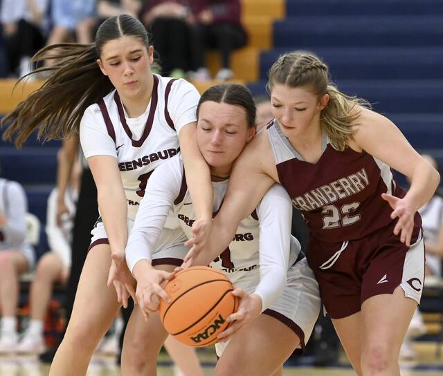 Greensburg Central’s Morgan Skoloda (left) and Avery Jones battle Cranberry’s Jadyn Shumaker for a loose ball during their PIAA Class 3A first round state playoff on Friday, Mar. 6, 2026, at Hampton. (Christopher Horner | TribLive)